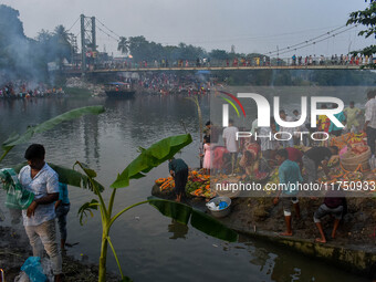 Devotees offer prayers to the sun god at a riverside 70 kilometers outside of Kolkata, India, on November 7, 2024, during the Chhath Puja fe...