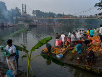 Devotees offer prayers to the sun god at a riverside 70 kilometers outside of Kolkata, India, on November 7, 2024, during the Chhath Puja fe...