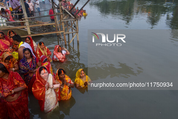 Devotees offer prayers to the sun god at a riverside 70 kilometers outside of Kolkata, India, on November 7, 2024, during the Chhath Puja fe...