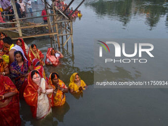 Devotees offer prayers to the sun god at a riverside 70 kilometers outside of Kolkata, India, on November 7, 2024, during the Chhath Puja fe...