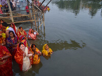 Devotees offer prayers to the sun god at a riverside 70 kilometers outside of Kolkata, India, on November 7, 2024, during the Chhath Puja fe...