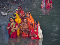 Devotees offer prayers to the sun god at a riverside 70 kilometers outside of Kolkata, India, on November 7, 2024, during the Chhath Puja fe...