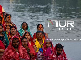 Devotees offer prayers to the sun god at a riverside 70 kilometers outside of Kolkata, India, on November 7, 2024, during the Chhath Puja fe...