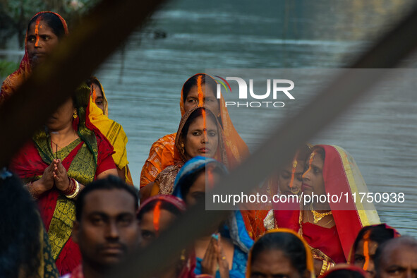 Devotees offer prayers to the sun god at a riverside 70 kilometers outside of Kolkata, India, on November 7, 2024, during the Chhath Puja fe...