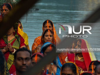 Devotees offer prayers to the sun god at a riverside 70 kilometers outside of Kolkata, India, on November 7, 2024, during the Chhath Puja fe...