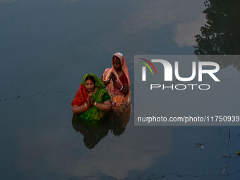 Devotees offer prayers to the sun god at a riverside 70 kilometers outside of Kolkata, India, on November 7, 2024, during the Chhath Puja fe...