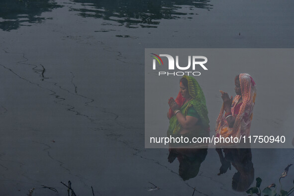 Devotees offer prayers to the sun god at a riverside 70 kilometers outside of Kolkata, India, on November 7, 2024, during the Chhath Puja fe...