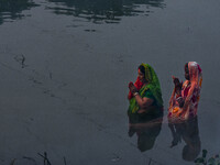 Devotees offer prayers to the sun god at a riverside 70 kilometers outside of Kolkata, India, on November 7, 2024, during the Chhath Puja fe...