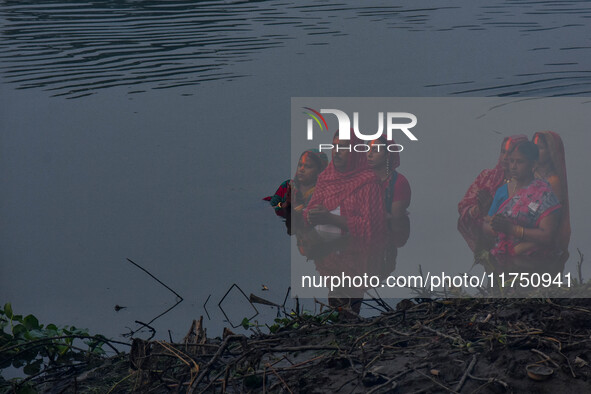 Devotees offer prayers to the sun god at a riverside 70 kilometers outside of Kolkata, India, on November 7, 2024, during the Chhath Puja fe...