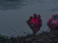 Devotees offer prayers to the sun god at a riverside 70 kilometers outside of Kolkata, India, on November 7, 2024, during the Chhath Puja fe...