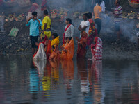 Devotees offer prayers to the sun god at a riverside 70 kilometers outside of Kolkata, India, on November 7, 2024, during the Chhath Puja fe...