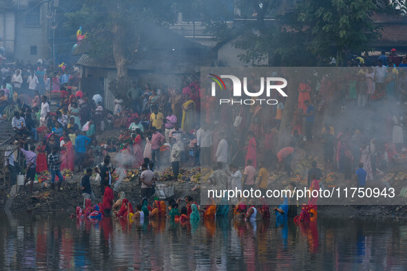 Devotees offer prayers to the sun god at a riverside 70 kilometers outside of Kolkata, India, on November 7, 2024, during the Chhath Puja fe...