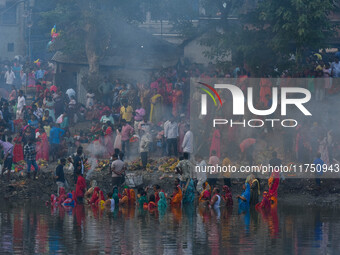 Devotees offer prayers to the sun god at a riverside 70 kilometers outside of Kolkata, India, on November 7, 2024, during the Chhath Puja fe...