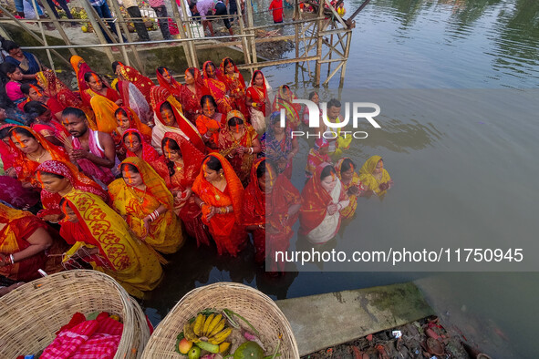 Devotees offer prayers to the sun god at a riverside 70 kilometers outside of Kolkata, India, on November 7, 2024, during the Chhath Puja fe...