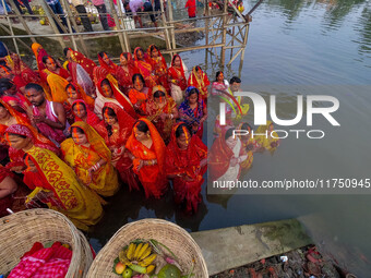 Devotees offer prayers to the sun god at a riverside 70 kilometers outside of Kolkata, India, on November 7, 2024, during the Chhath Puja fe...