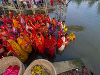 Devotees offer prayers to the sun god at a riverside 70 kilometers outside of Kolkata, India, on November 7, 2024, during the Chhath Puja fe...