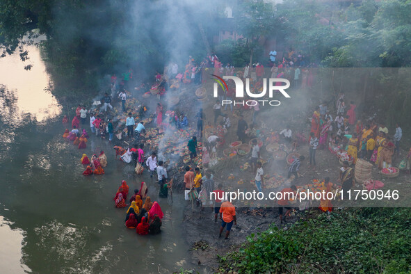 Devotees offer prayers to the sun god at a riverside 70 kilometers outside of Kolkata, India, on November 7, 2024, during the Chhath Puja fe...