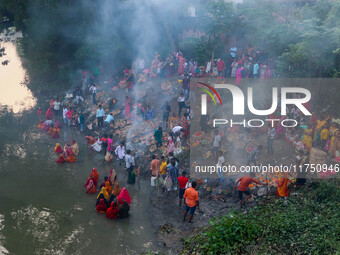 Devotees offer prayers to the sun god at a riverside 70 kilometers outside of Kolkata, India, on November 7, 2024, during the Chhath Puja fe...