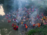 Devotees offer prayers to the sun god at a riverside 70 kilometers outside of Kolkata, India, on November 7, 2024, during the Chhath Puja fe...