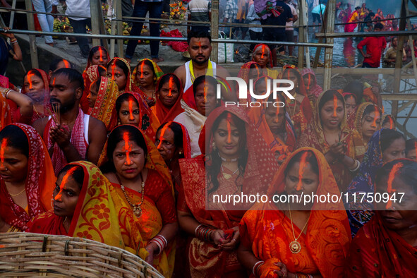 Devotees offer prayers to the sun god at a riverside 70 kilometers outside of Kolkata, India, on November 7, 2024, during the Chhath Puja fe...