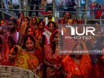 Devotees offer prayers to the sun god at a riverside 70 kilometers outside of Kolkata, India, on November 7, 2024, during the Chhath Puja fe...