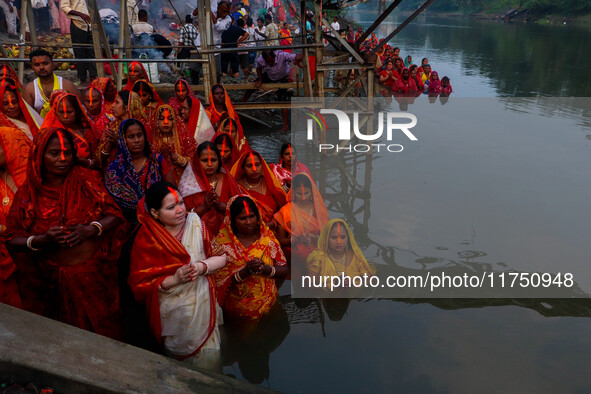 Devotees offer prayers to the sun god at a riverside 70 kilometers outside of Kolkata, India, on November 7, 2024, during the Chhath Puja fe...