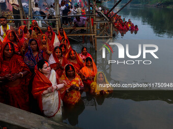 Devotees offer prayers to the sun god at a riverside 70 kilometers outside of Kolkata, India, on November 7, 2024, during the Chhath Puja fe...