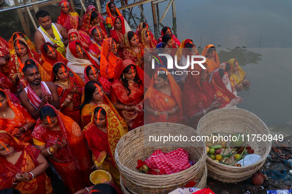 Devotees offer prayers to the sun god at a riverside 70 kilometers outside of Kolkata, India, on November 7, 2024, during the Chhath Puja fe...