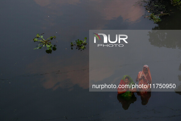 Devotees offer prayers to the sun god at a riverside 70 kilometers outside of Kolkata, India, on November 7, 2024, during the Chhath Puja fe...