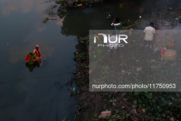 Devotees offer prayers to the sun god at a riverside 70 kilometers outside of Kolkata, India, on November 7, 2024, during the Chhath Puja fe...