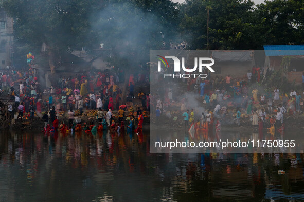 Devotees offer prayers to the sun god at a riverside 70 kilometers outside of Kolkata, India, on November 7, 2024, during the Chhath Puja fe...