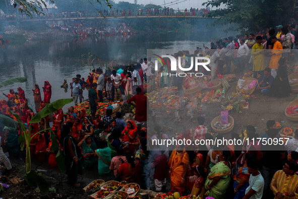 Devotees offer prayers to the sun god at a riverside 70 kilometers outside of Kolkata, India, on November 7, 2024, during the Chhath Puja fe...