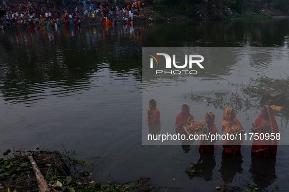 Devotees offer prayers to the sun god at a riverside 70 kilometers outside of Kolkata, India, on November 7, 2024, during the Chhath Puja fe...