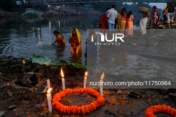 Devotees offer prayers to the sun god at a riverside 70 kilometers outside of Kolkata, India, on November 7, 2024, during the Chhath Puja fe...