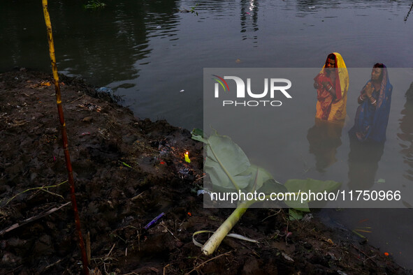 Devotees offer prayers to the sun god at a riverside 70 kilometers outside of Kolkata, India, on November 7, 2024, during the Chhath Puja fe...