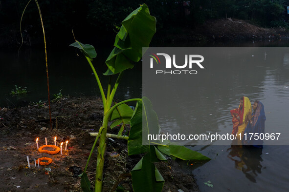 Devotees offer prayers to the sun god at a riverside 70 kilometers outside of Kolkata, India, on November 7, 2024, during the Chhath Puja fe...