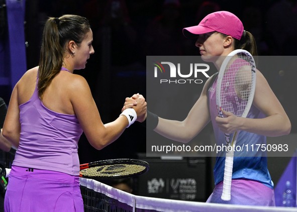 RIYADH, SAUDI ARABIA - NOVEMBER 07: Daria Kasatkina congratulates Iga Swiatek of Poland after their match, on Day 6 of the 2024 WTA Finals,...