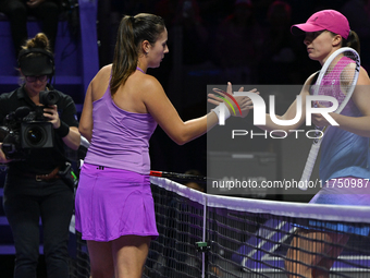 RIYADH, SAUDI ARABIA - NOVEMBER 07: Daria Kasatkina congratulates Iga Swiatek of Poland after their match, on Day 6 of the 2024 WTA Finals,...