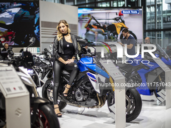 A model poses on a Suzuki GSX-S 1000 at the 110th International Motorcycle and Accessories Exhibition 2024 at Fiera Milano Rho in Milan, Ita...