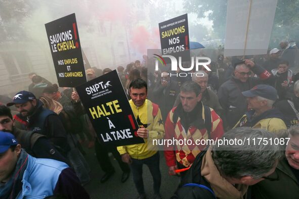 Protesters hold a placard that reads ''Stop taxing!'', ''No to taxation of horse-race betting!'' and ''Let's save the horse! our jobs and ou...