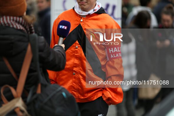 A protester wearing orange jockeys' silks and an armband reading ''Stop the tax'' speaks with the press as he participates in a demonstratio...