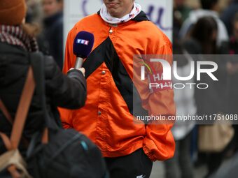 A protester wearing orange jockeys' silks and an armband reading ''Stop the tax'' speaks with the press as he participates in a demonstratio...