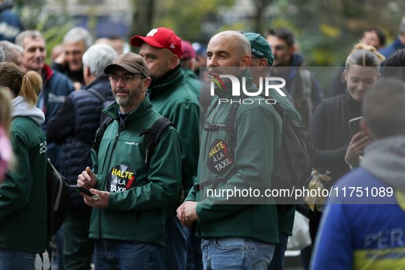 Protesters wearing green jackets from the Chantilly Hippodrome that read ''Stop the tax'' take part in a demonstration organized by horse ra...