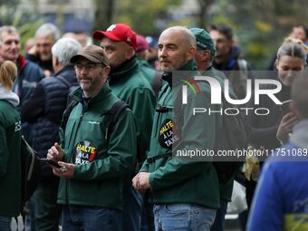 Protesters wearing green jackets from the Chantilly Hippodrome that read ''Stop the tax'' take part in a demonstration organized by horse ra...