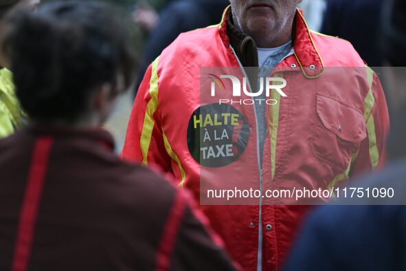 A protester wears red jockeys' silks reading ''Stop the tax'' and takes part in a demonstration organized by horse racing associations and p...