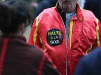 A protester wears red jockeys' silks reading ''Stop the tax'' and takes part in a demonstration organized by horse racing associations and p...