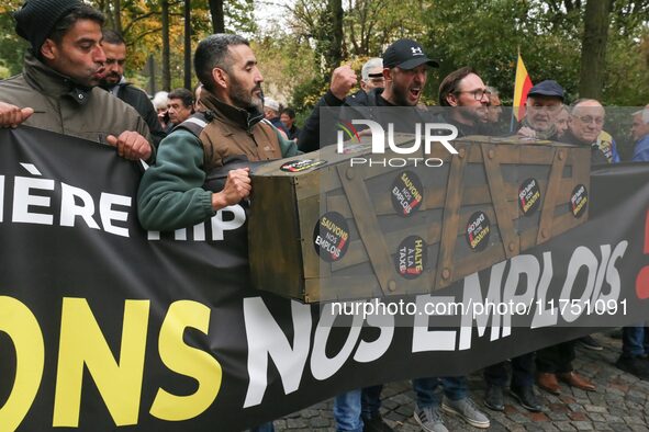 Protesters hold a banner reading ''Keep jobs'' as they participate in a demonstration organized by horse racing associations and professiona...