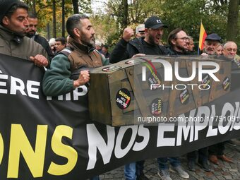 Protesters hold a banner reading ''Keep jobs'' as they participate in a demonstration organized by horse racing associations and professiona...