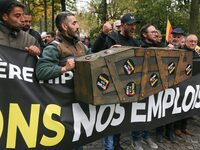 Protesters hold a banner reading ''Keep jobs'' as they participate in a demonstration organized by horse racing associations and professiona...