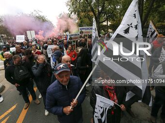 Protesters hold a placard that reads ''Stop taxing!'', ''No to taxation of horse-race betting!'' and ''Let's save the horse! our jobs and ou...